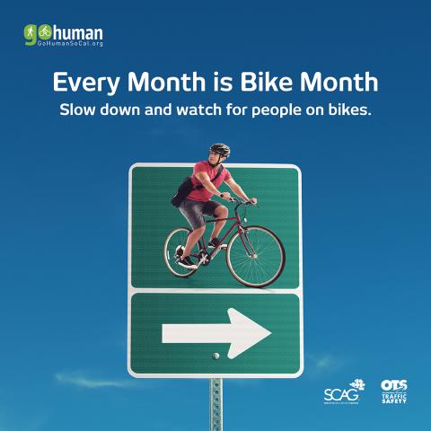Cyclist on a bike sign, clear blue sky.